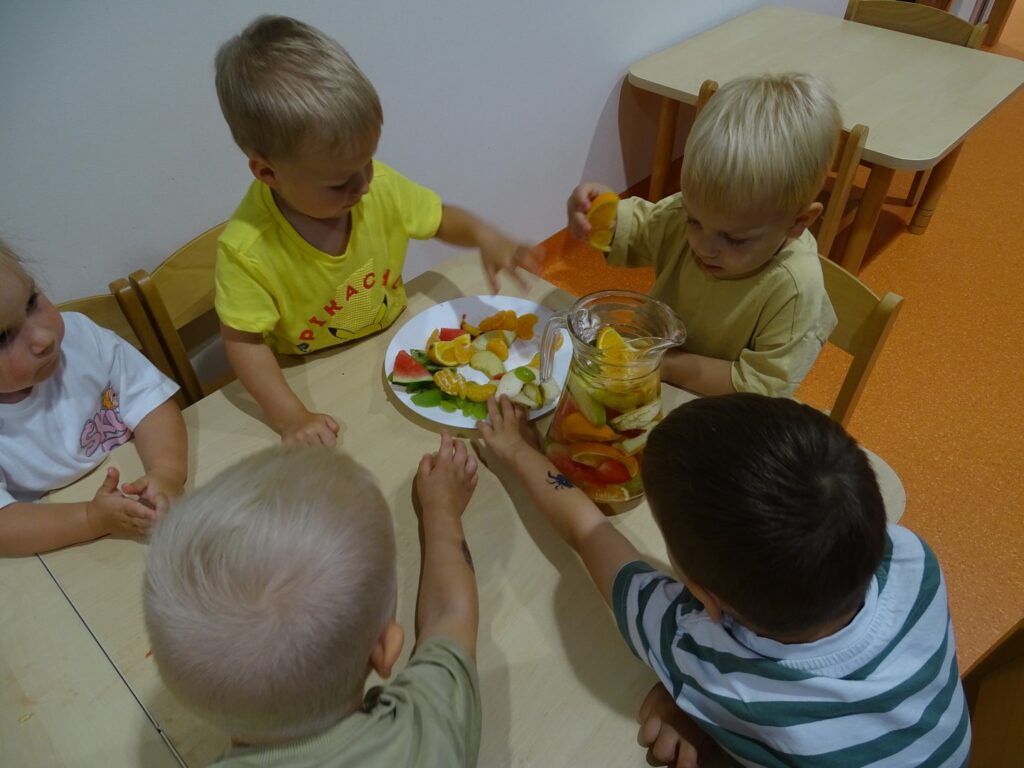 Chłopcy wrzucają owoce