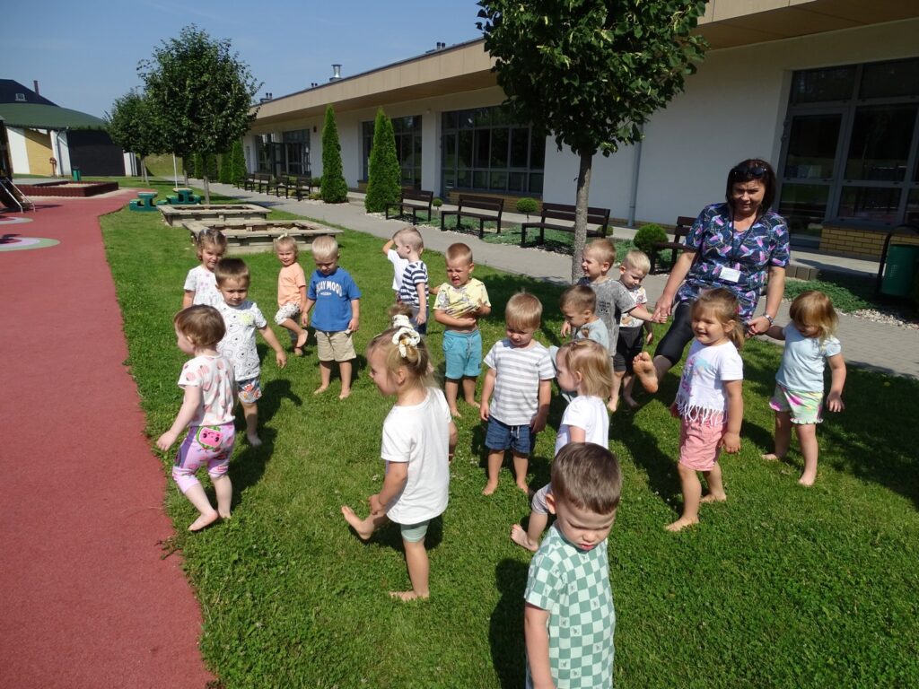 Dzieci chodzą boso po trawie