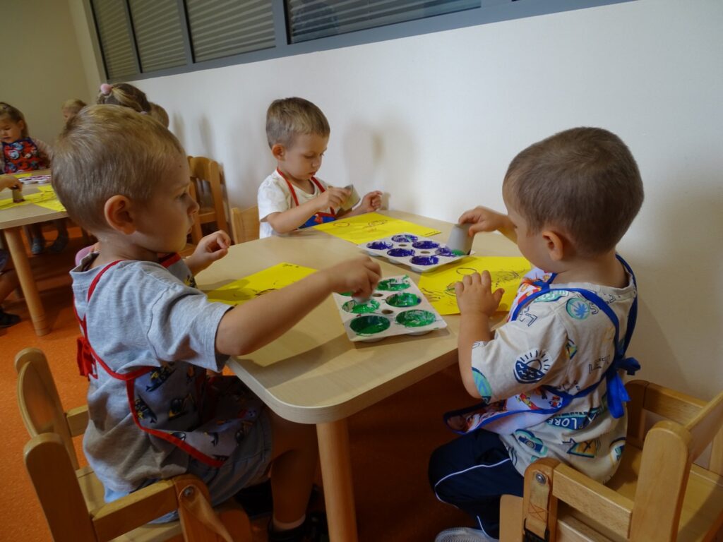 Chłopcy pracują z farbami