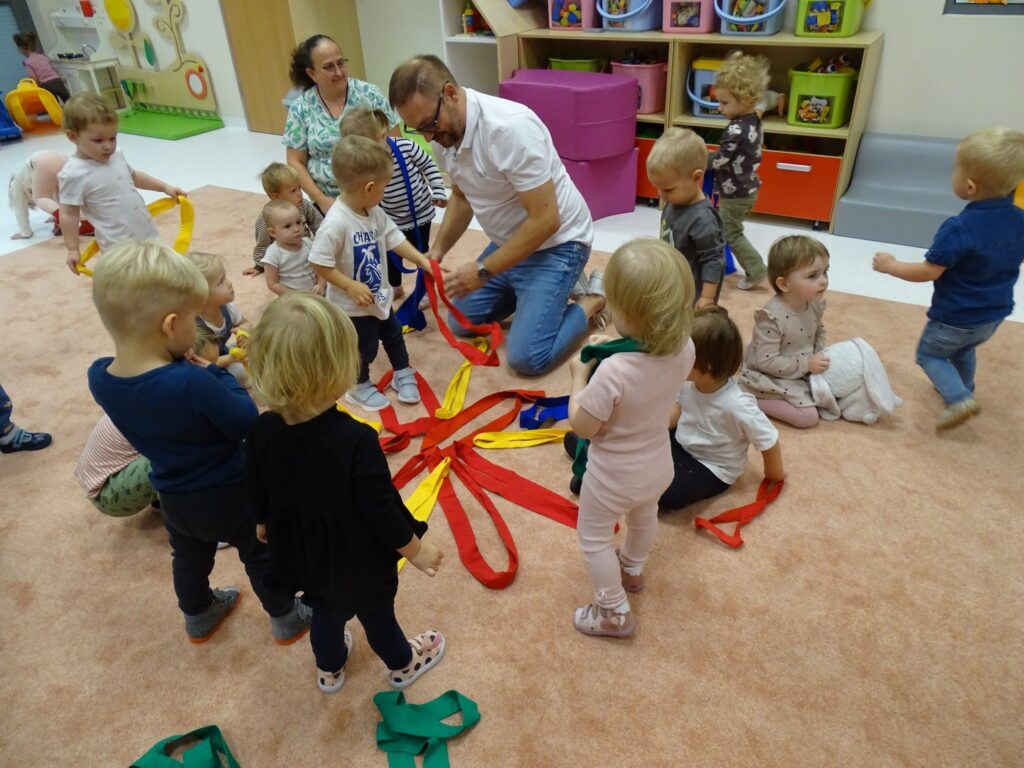 Dzieci podają kolorowe szarfy