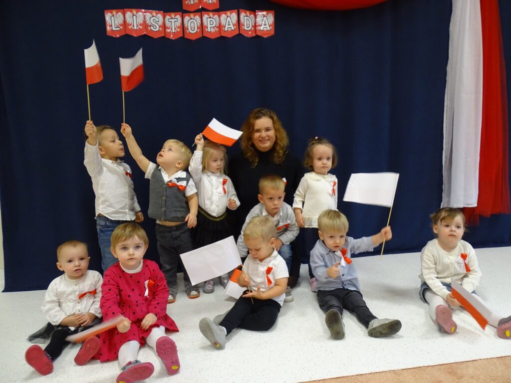 Dzieci pozują do zdjęcia z flagami