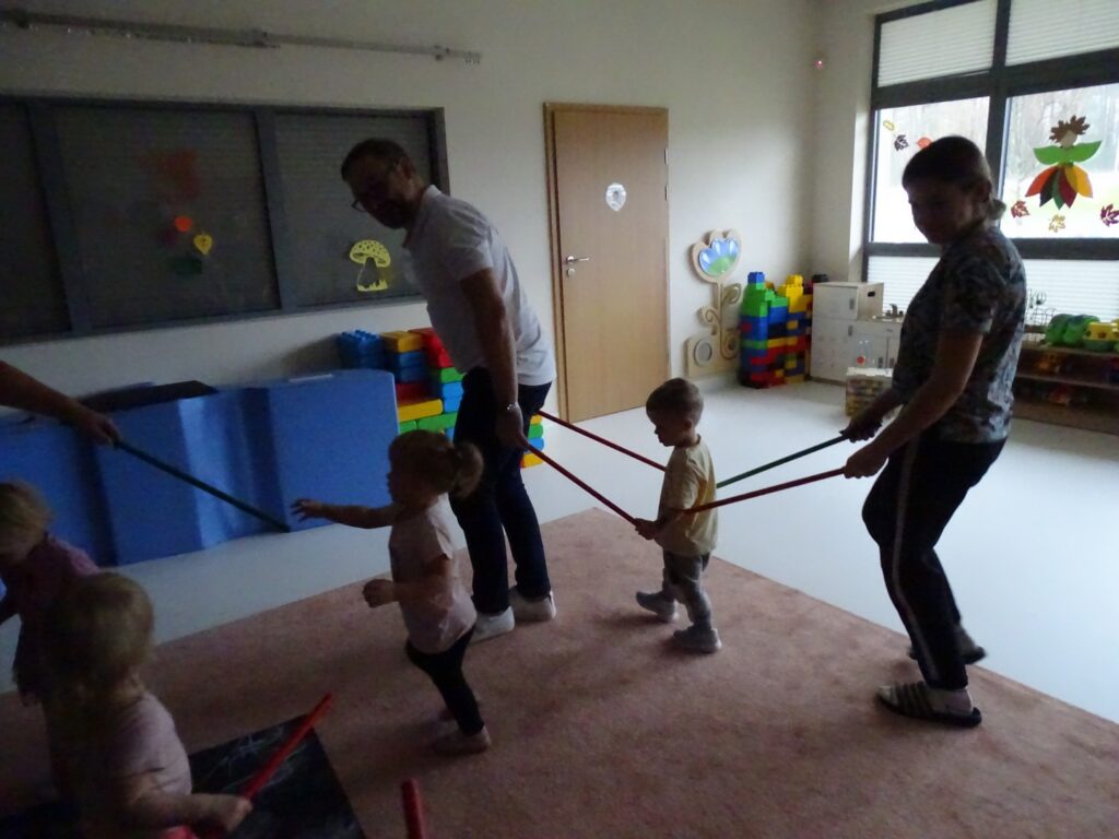 Dzieci z opiekunami tworzą wagoniki