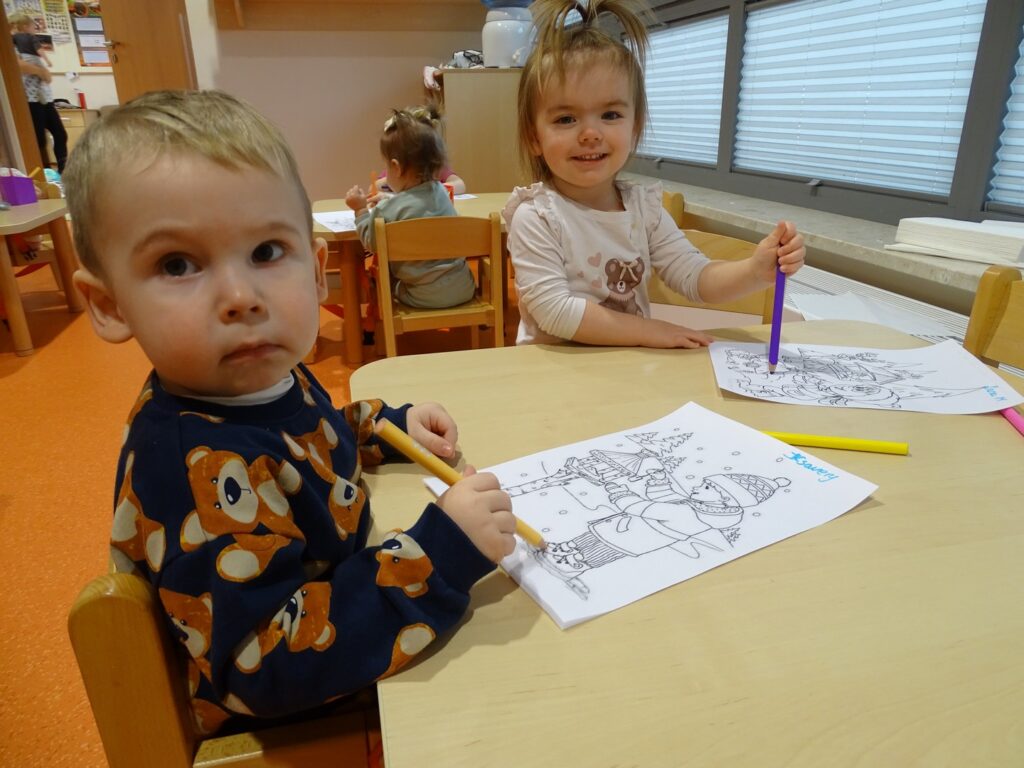 Dziewczynka z chłopcem koloruje kredkami