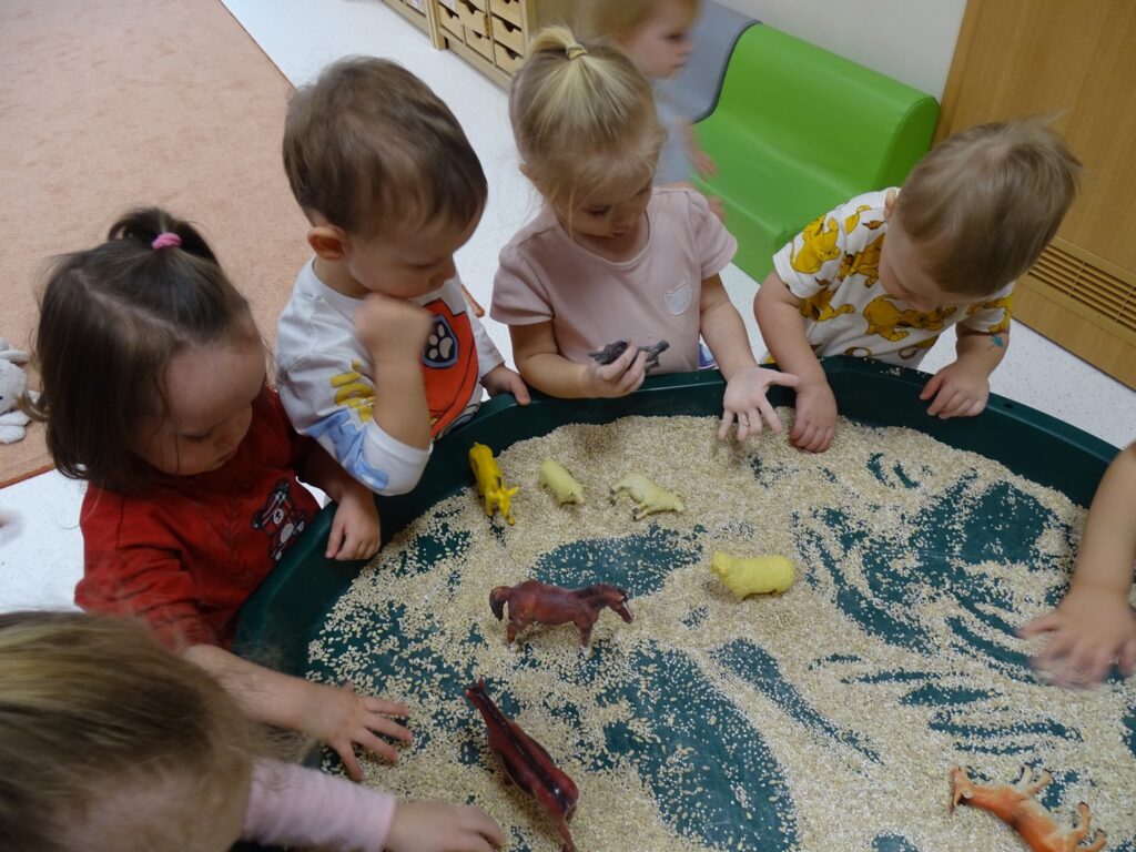 Dzieci karmią zabawkowe zwierzątka