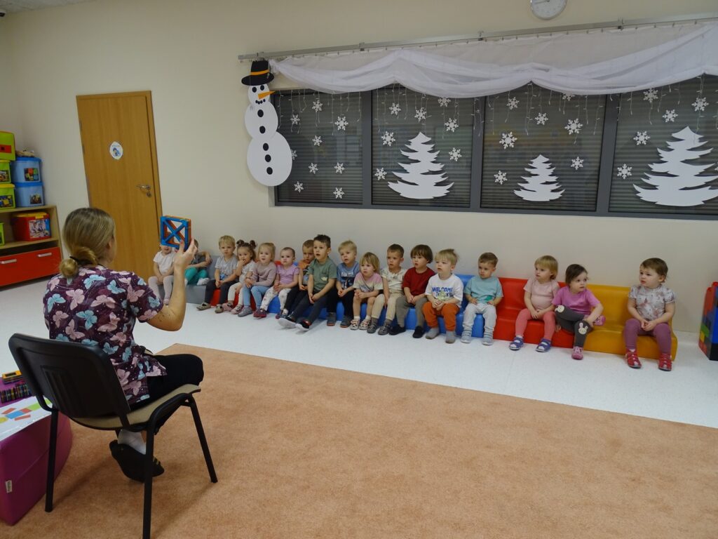 Dzieci słuchają informacji na temat figur geometrycznych