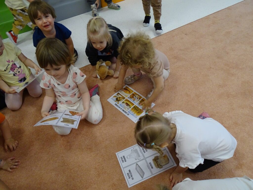 Dzieci oglądają karty pracy dotyczące zawodów