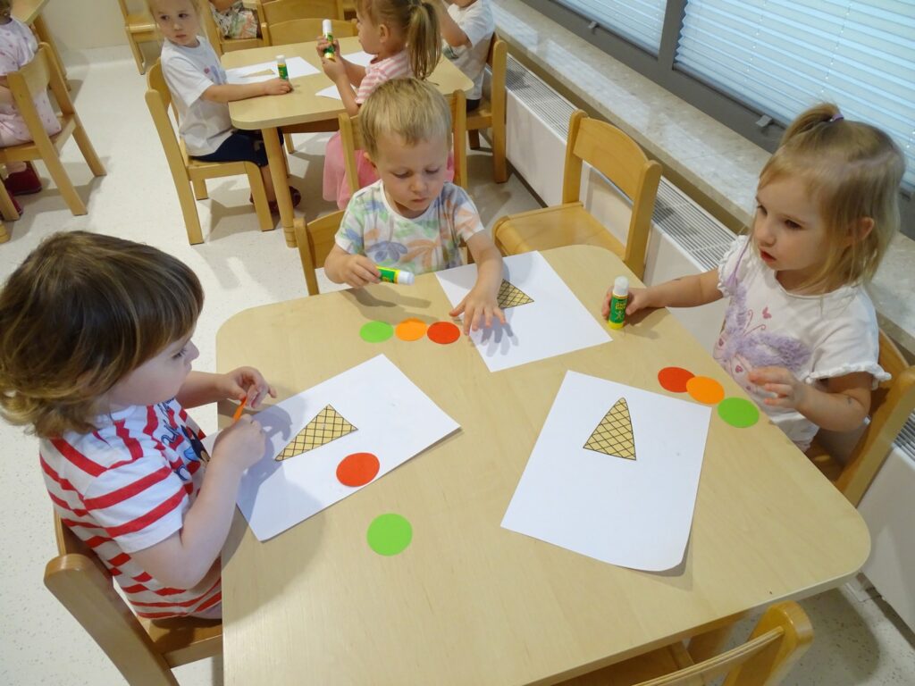 Dzieci naklejają kółeczka